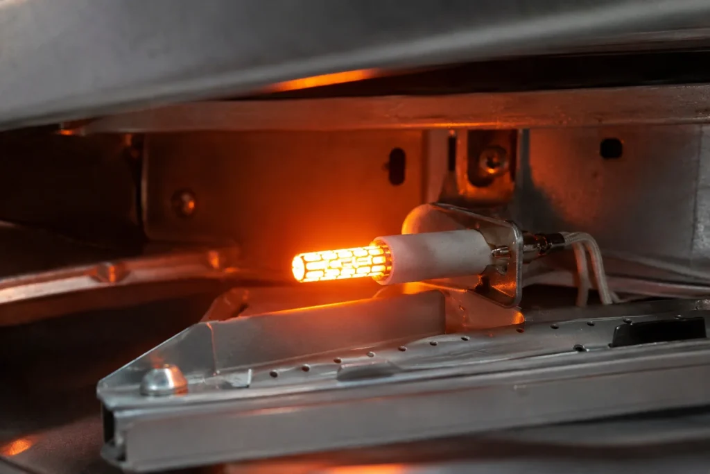 gas oven igniter glowing before burner ignition